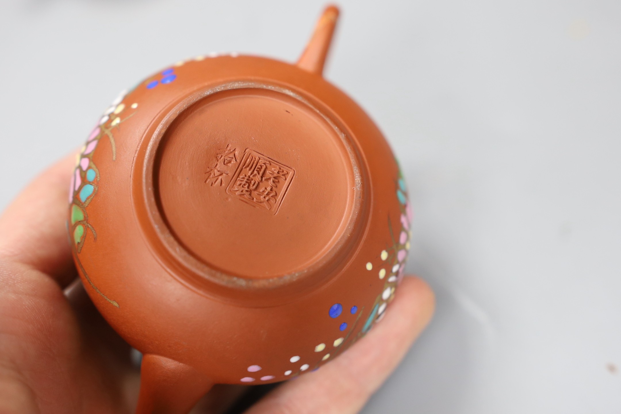 Four Chinese Yixing graduated enamelled miniature teapots, largest 5.5cms high